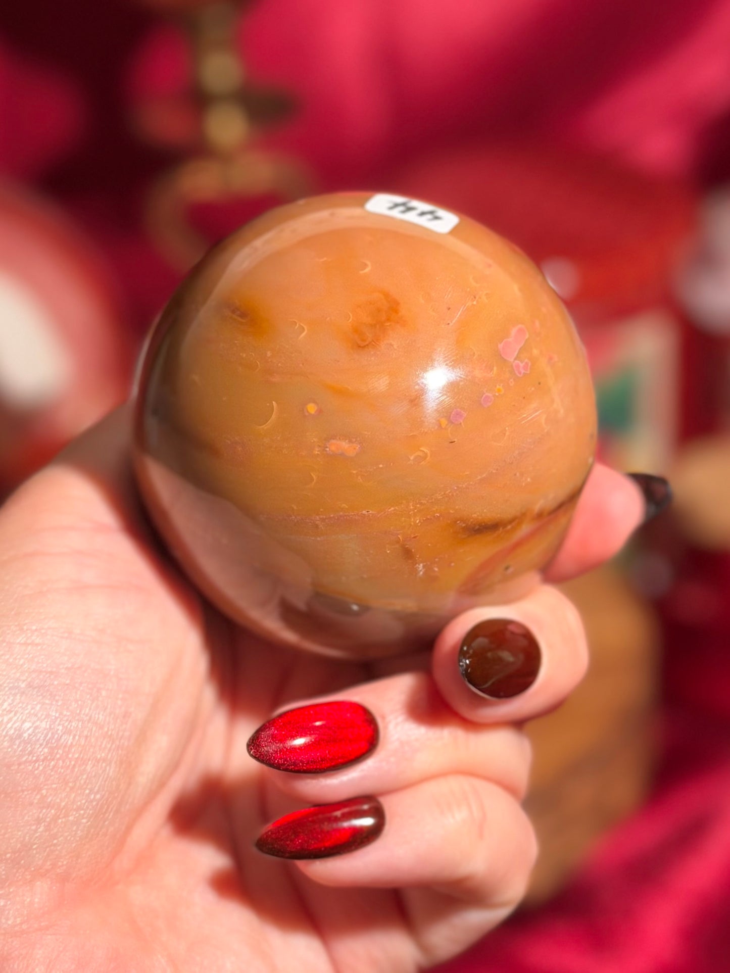 Terracotta pink zebra jasper sphere with a natural moon shaped pattern