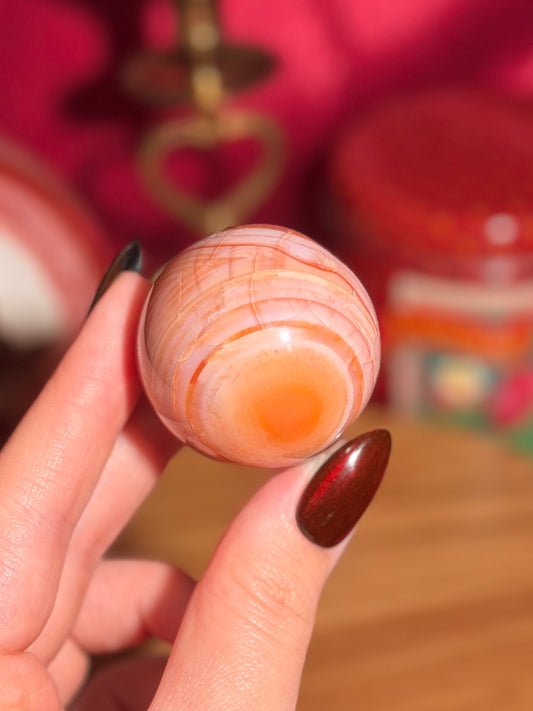 Peachy pink carnelian sphere