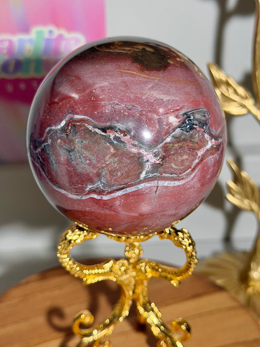Strawberry red petrified wood sphere from Madagascar