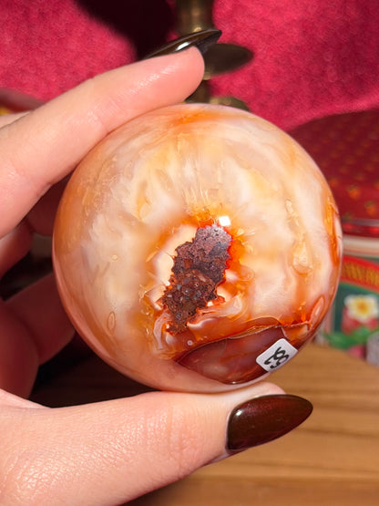 Glowy yellow carnelian sphere with imperfect fill spots