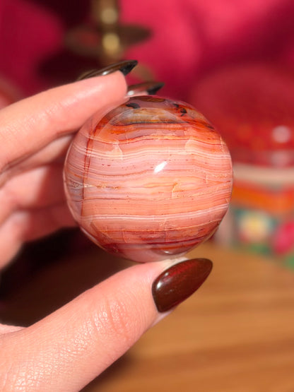 Pink banded carnelian sphere