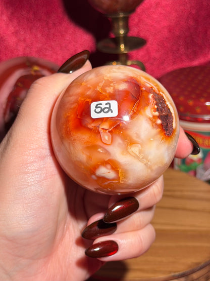 Glowy yellow carnelian sphere with imperfect fill spots