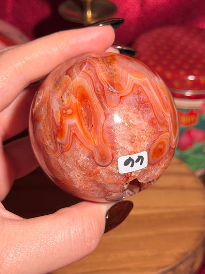 Mossy carnelian sphere with quartz cave