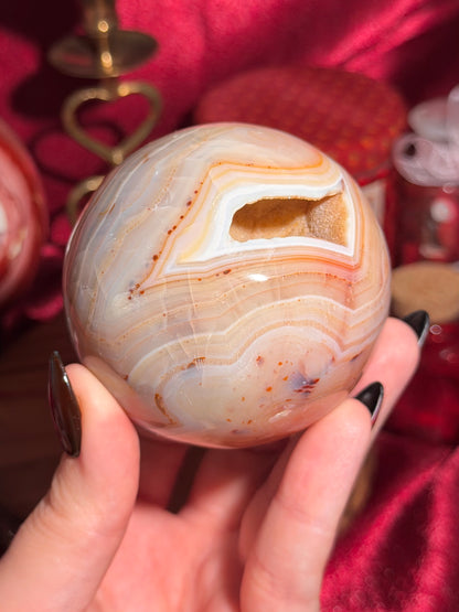 Pastel yellow and peachy toned carnelian sphere with large druzy cave 72mm