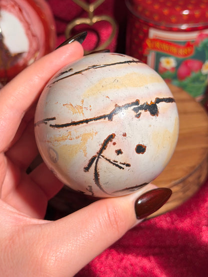Pink and yellow Chinese picture jasper sphere with unique patterns