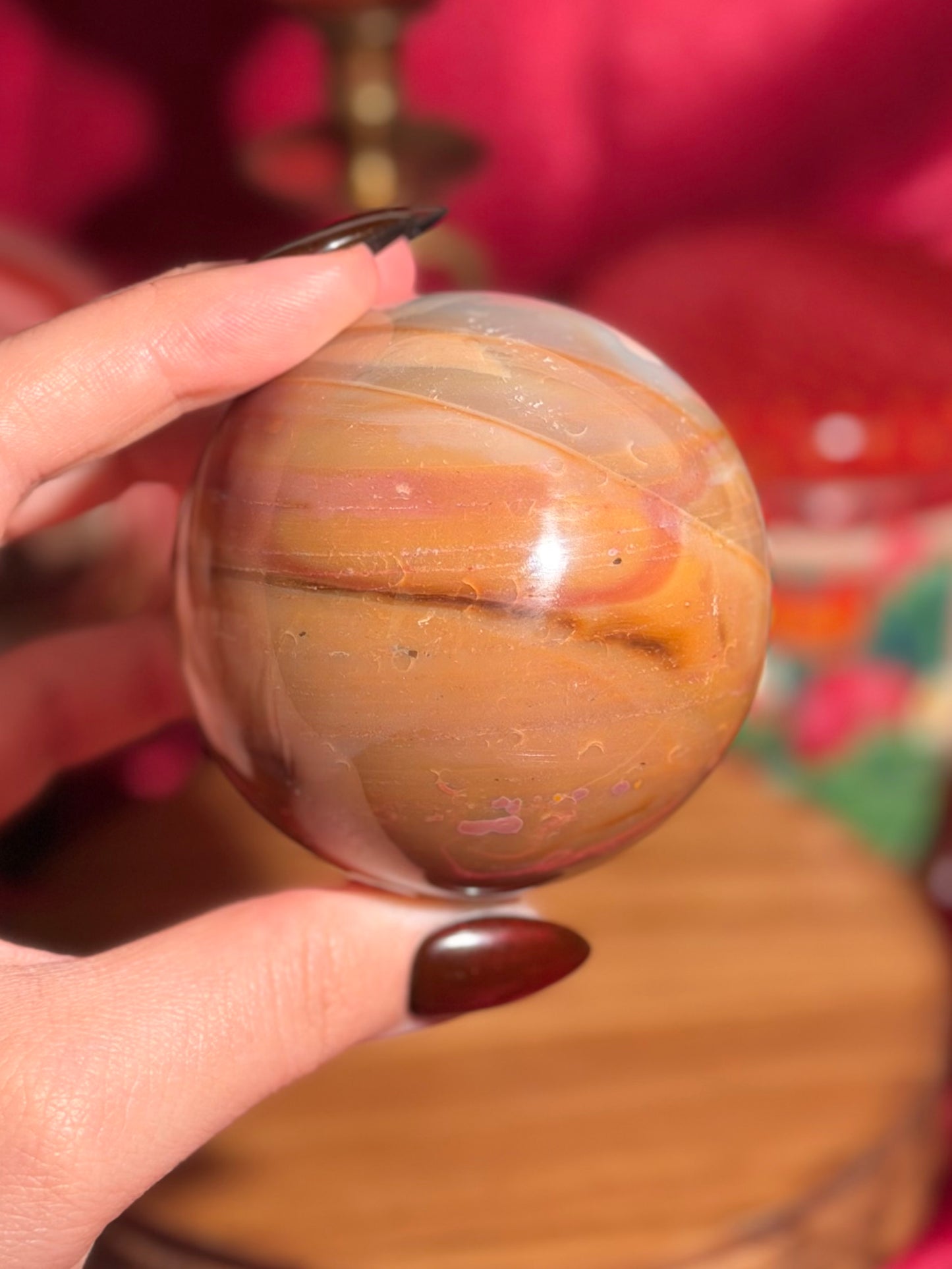 Terracotta pink zebra jasper sphere with a natural moon shaped pattern