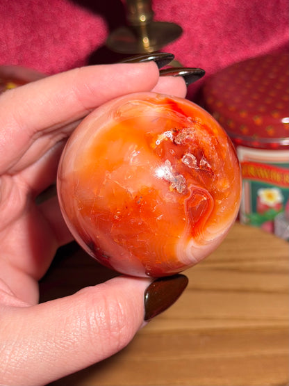 Funky banded carnelian sphere with moss inclusions