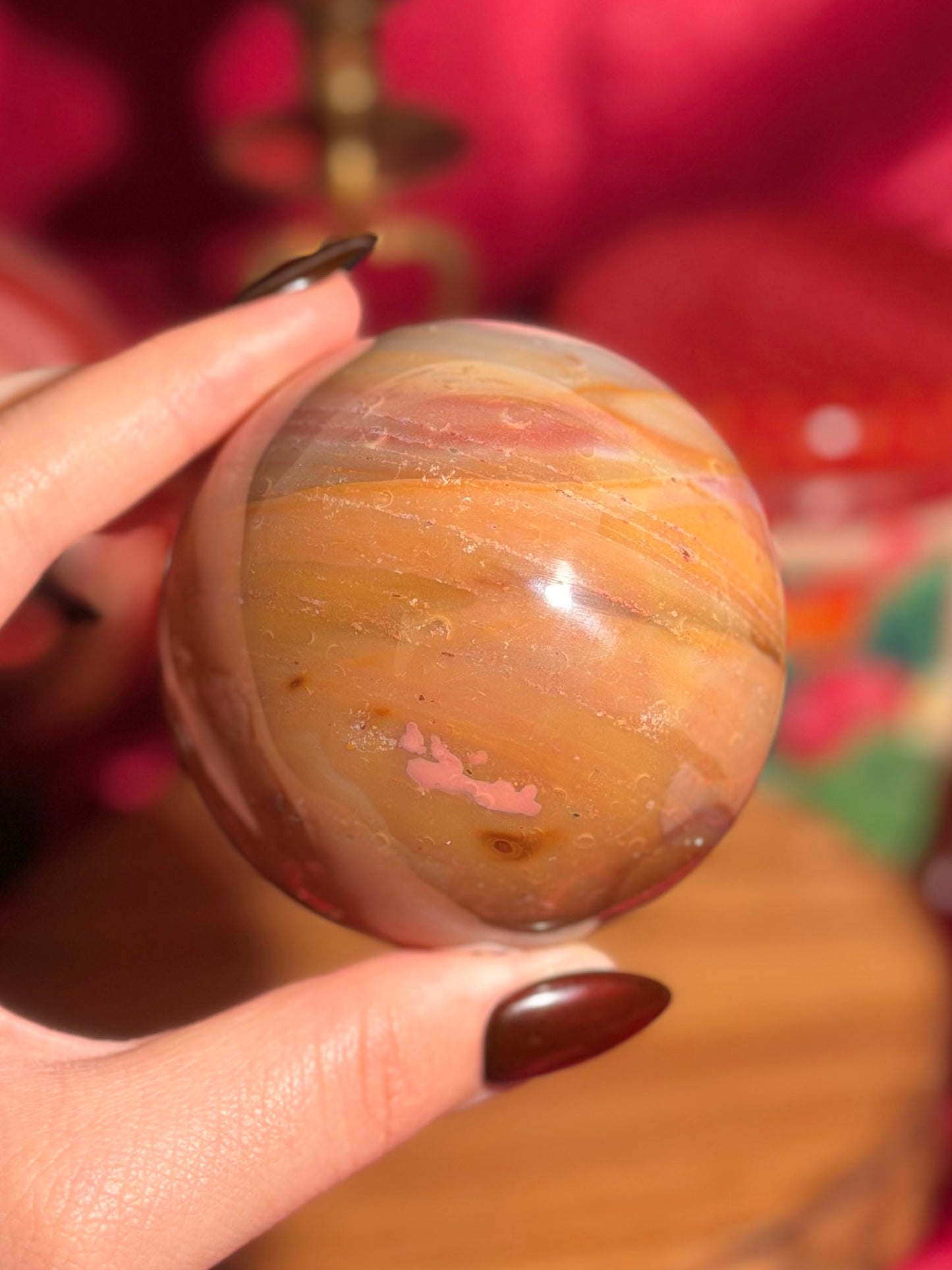 Terracotta pink zebra jasper sphere with a natural moon shaped pattern