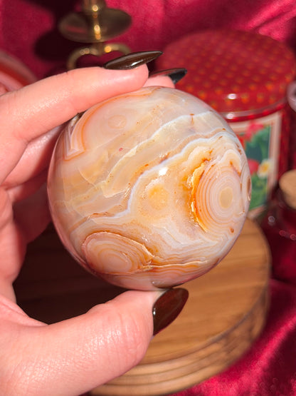 Pastel yellow and peachy toned carnelian sphere with large druzy cave 72mm