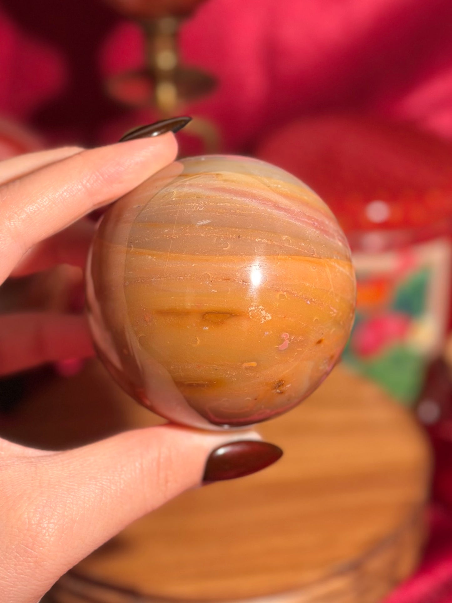 Terracotta pink zebra jasper sphere with a natural moon shaped pattern