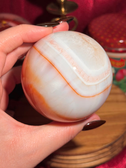 Pastel cool toned pink carnelian sphere with quartz 75mm