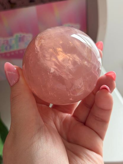 Juicy pink star rose quartz sphere with rainbows