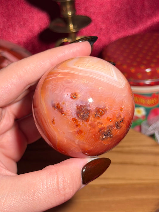 Funky banded carnelian sphere with moss inclusions