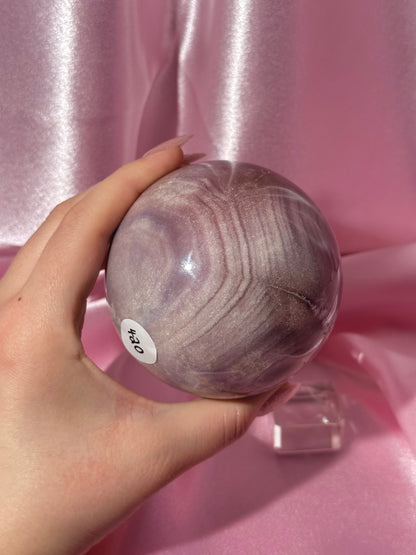 Lavender-toned glittery Brazilian pink amethyst sphere with stunning quartz cave