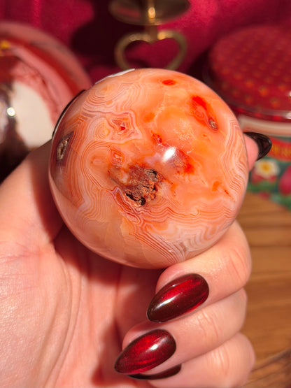 Peachy pink carnelian sphere with adorable scalloped banding