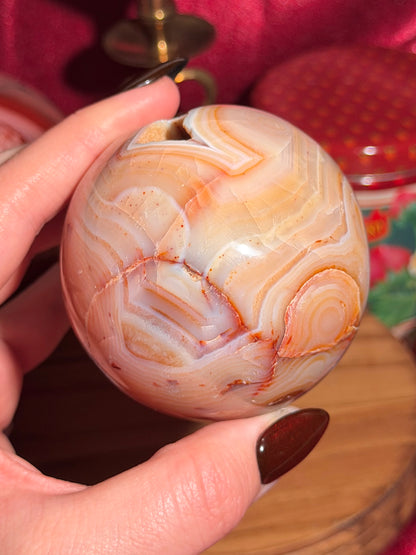 Pastel yellow and peachy toned carnelian sphere with large druzy cave 72mm