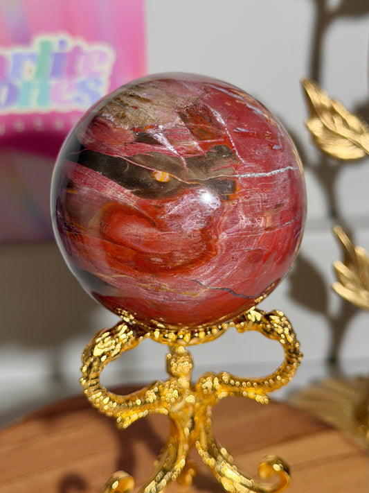 Strawberry red petrified wood sphere from Madagascar