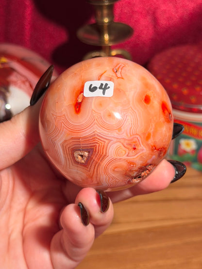 Peachy pink carnelian sphere with adorable scalloped banding