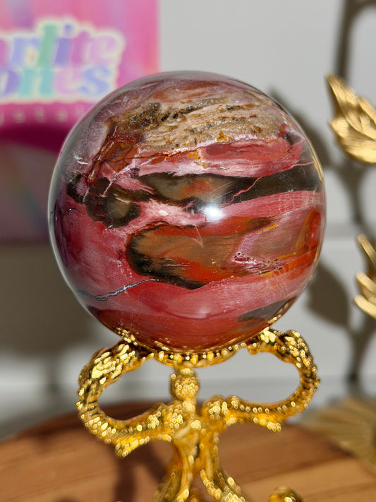 Strawberry red petrified wood sphere from Madagascar