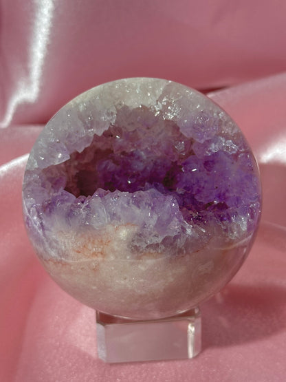 Brazilian pink amethyst sphere with purple druzy cave