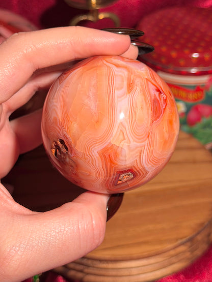 Peachy pink carnelian sphere with adorable scalloped banding
