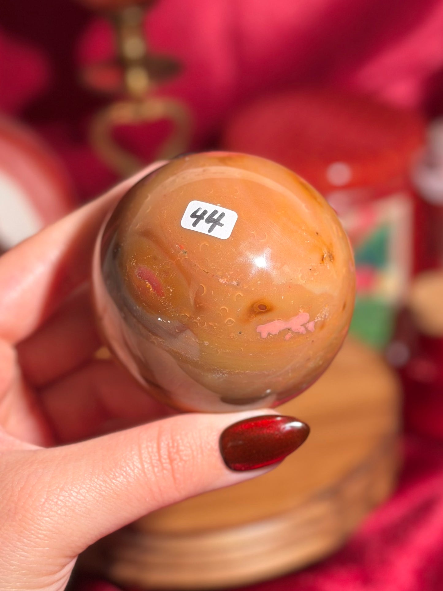 Terracotta pink zebra jasper sphere with a natural moon shaped pattern