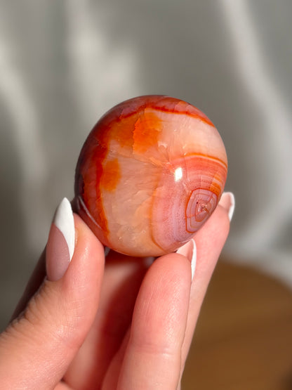 Pink banded carnelian palmstone