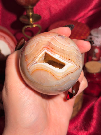 Pastel yellow and peachy toned carnelian sphere with large druzy cave 72mm