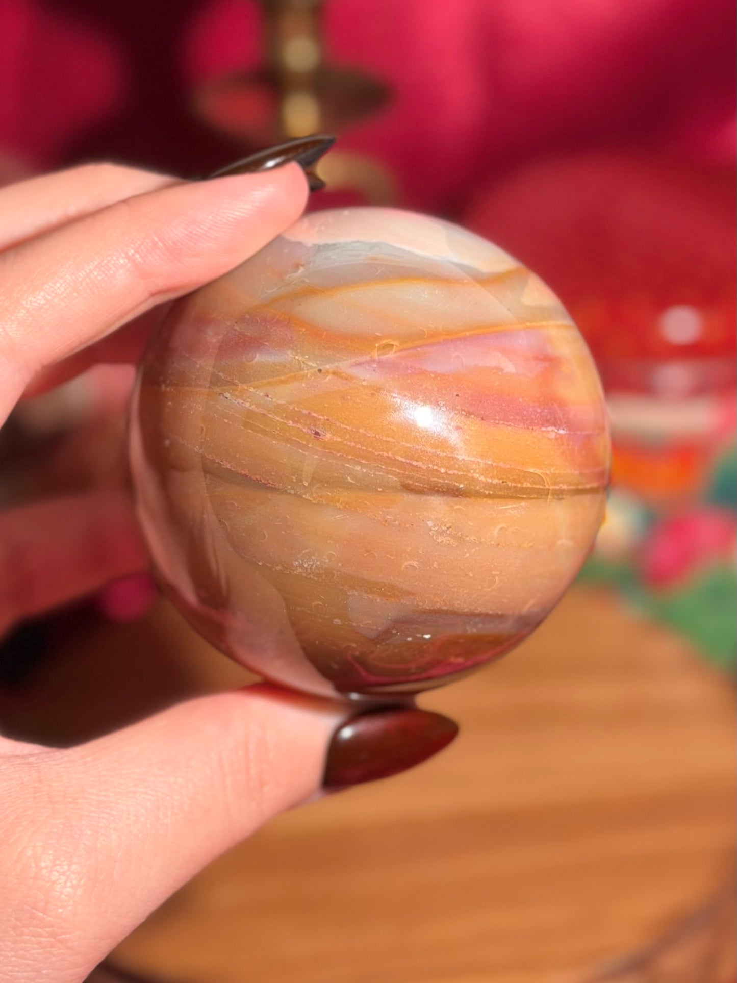 Terracotta pink zebra jasper sphere with a natural moon shaped pattern