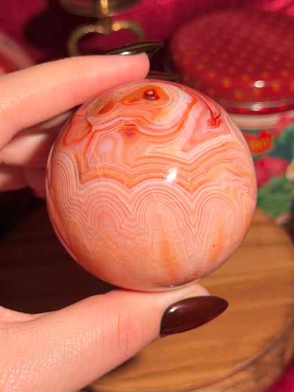 Peachy pink carnelian sphere with adorable scalloped banding