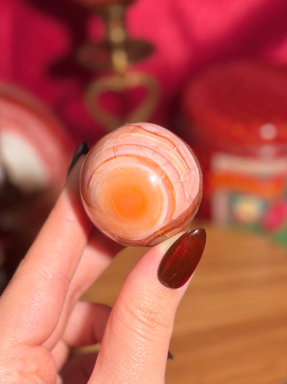 Peachy pink carnelian sphere