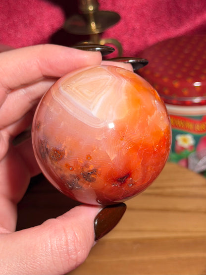 Funky banded carnelian sphere with moss inclusions
