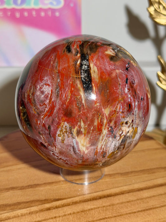 Vampy red and black petrified wood sphere from Madagascar