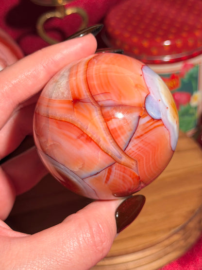 Rainbow banded carnelian sphere 65mm