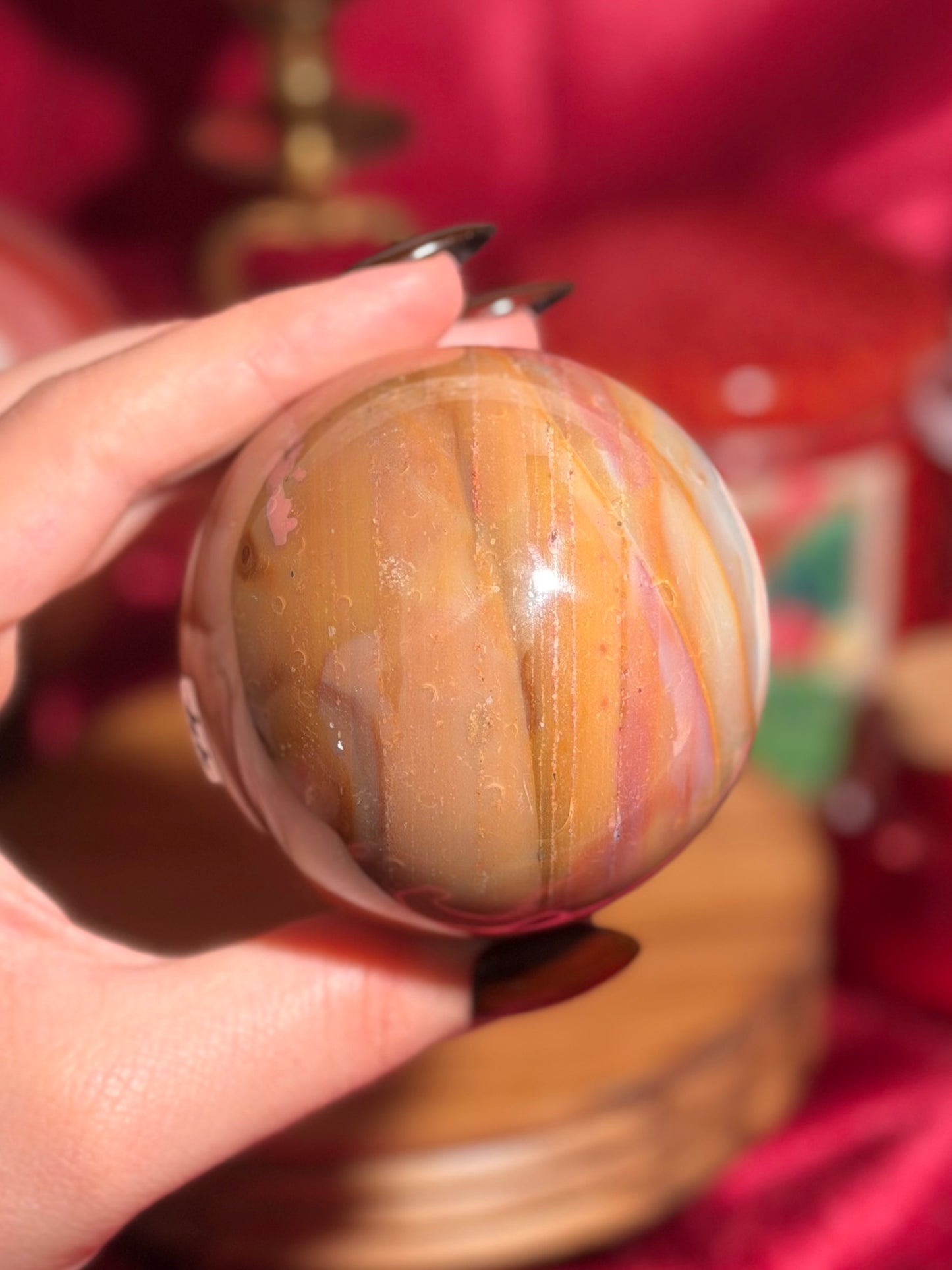 Terracotta pink zebra jasper sphere with a natural moon shaped pattern
