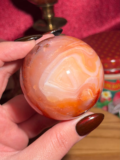 Funky banded carnelian sphere with moss inclusions