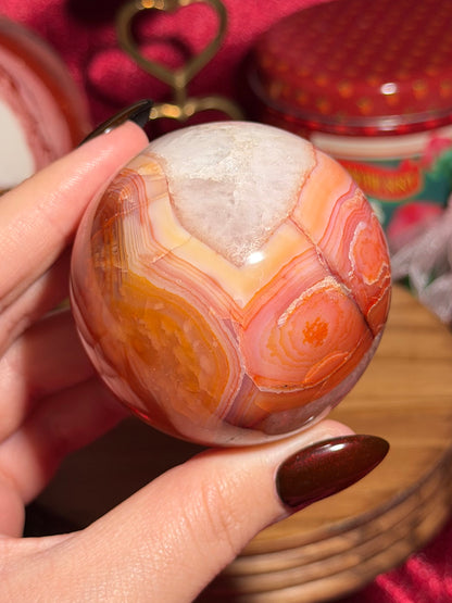 Rainbow carnelian sphere with quartz