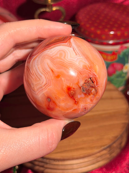Peachy pink carnelian sphere with adorable scalloped banding