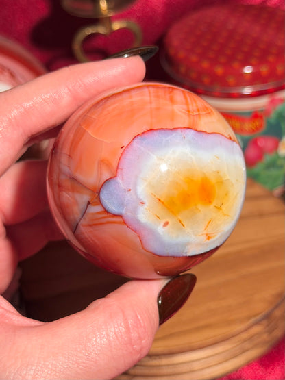 Rainbow banded carnelian sphere 65mm