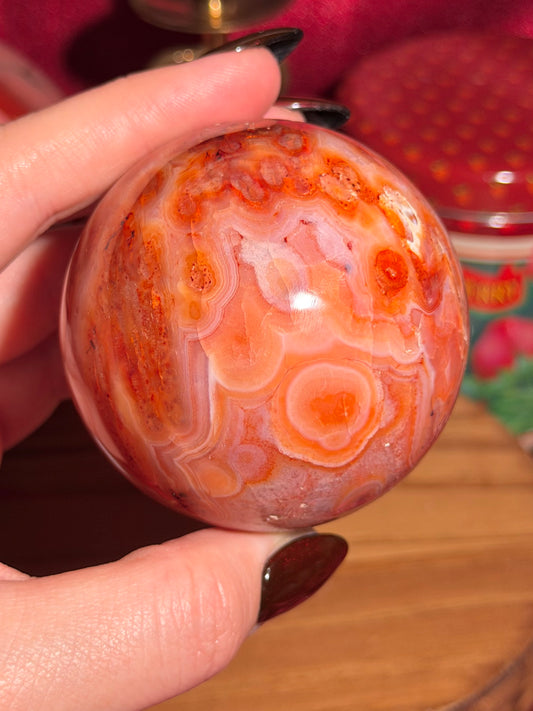 Mossy carnelian sphere with quartz cave