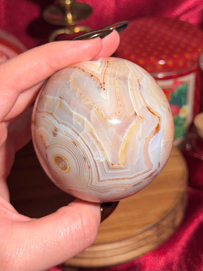 Pastel yellow and peachy toned carnelian sphere with large druzy cave 72mm