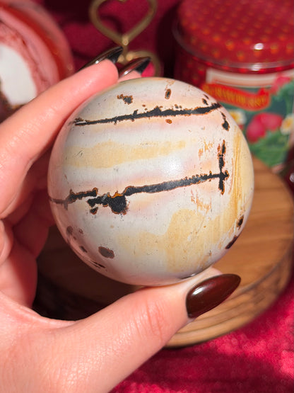 Pink and yellow Chinese picture jasper sphere with unique patterns