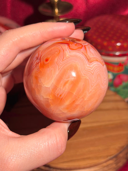 Peachy pink carnelian sphere with adorable scalloped banding