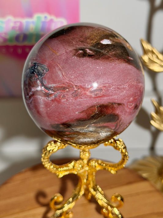 Strawberry red petrified wood sphere from Madagascar