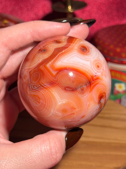 Pink banded carnelian sphere