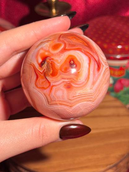Peachy pink carnelian sphere with adorable scalloped banding