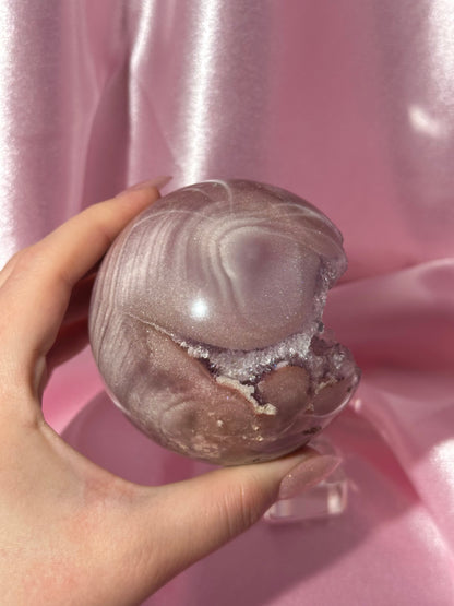 Lavender-toned glittery Brazilian pink amethyst sphere with stunning quartz cave