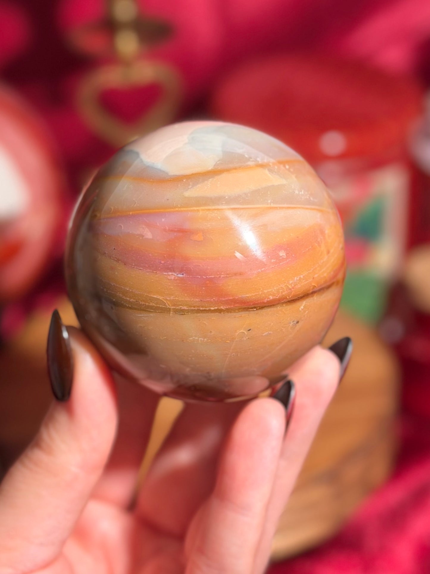 Terracotta pink zebra jasper sphere with a natural moon shaped pattern