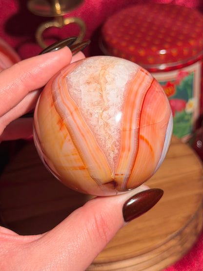 Rainbow banded carnelian sphere 65mm