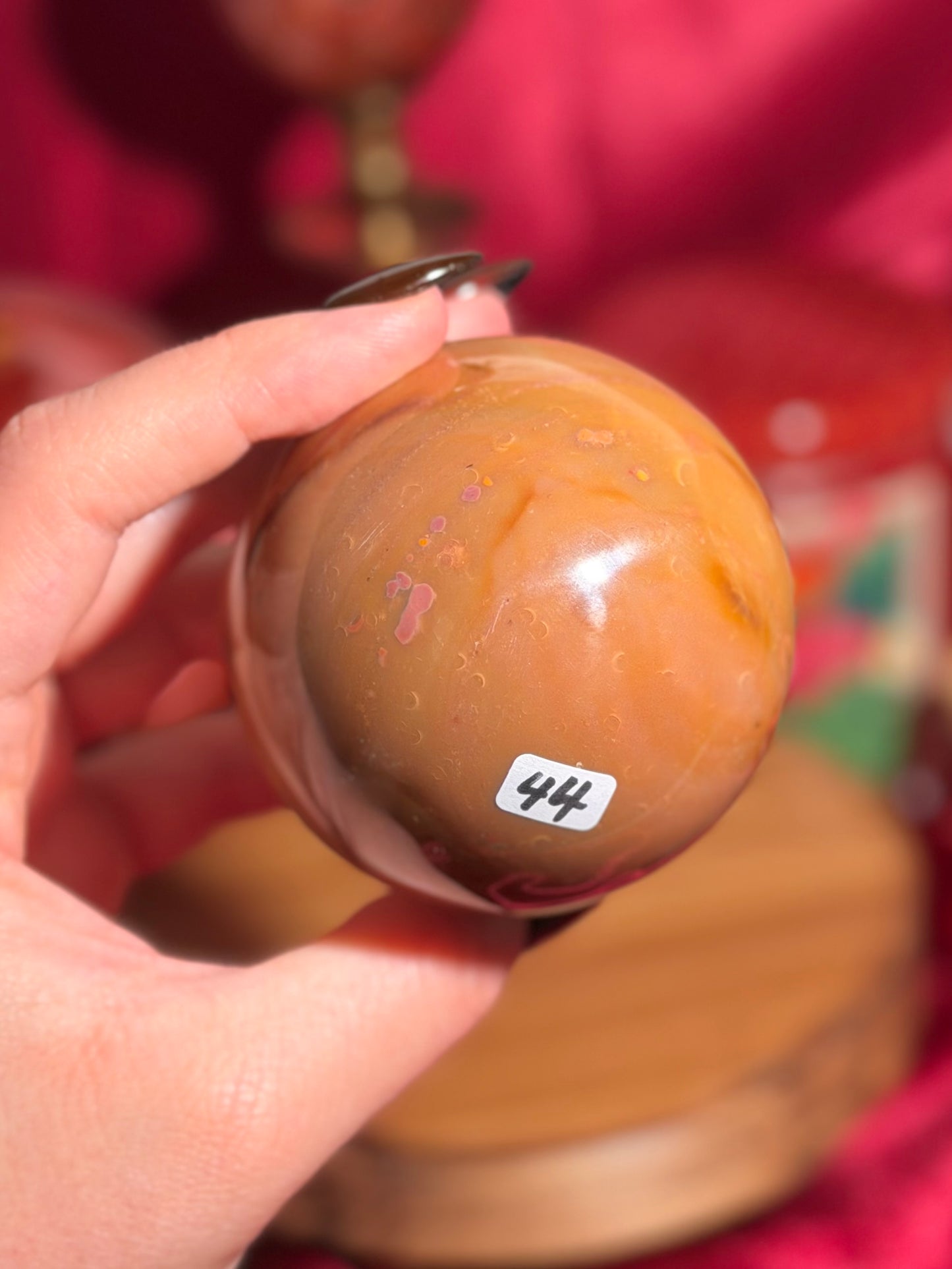 Terracotta pink zebra jasper sphere with a natural moon shaped pattern